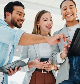 Screenshot of three colleagues looking at a tablet screen