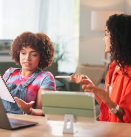 Two woman working and discussing a business plan