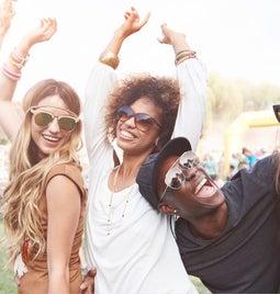 A group of 5 friends dancing together at a festival
