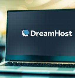 Laptop screen showing the DreamHost logo against a black background