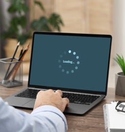 Laptop screen showing a loading icon