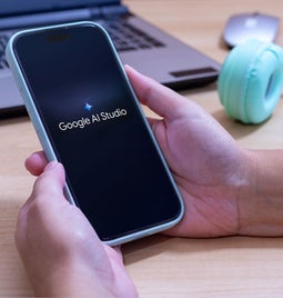 A person holds a smartphone displaying the 