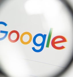 Magnifying glass over the Google search homepage