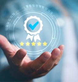 Palm facing up with a icon of a badge and five stars floating in the hand