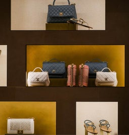 A store display featuring luxury handbags and jewelery