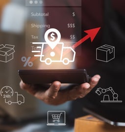 Person holding a tablet with floating images around it to reflect them weighing up shipping fees