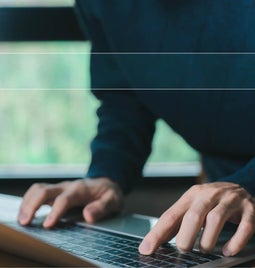 A man typing on a keyboard with an overlay graphic of a search bar on top