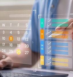 Digital image of a calendar and colour coded checklist floating above a laptop with a hand pointing to the list with a stylus