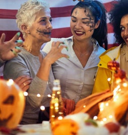 Group of people in fancy dress celebrating at a Halloween party