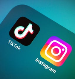 close up of iPhone app folder with TikTok and Instagram in it