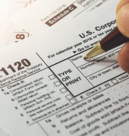 Person filling out a US tax form