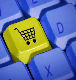 Keyboard buttons with a shopping cart button in yellow sitting replacing a letter button