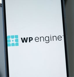 Closeup of a phone with the WP Engine logo on the screen